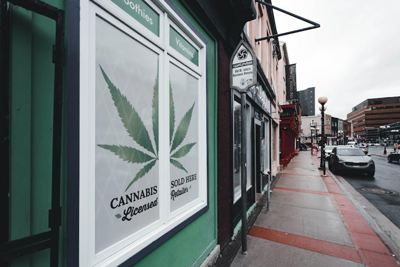A modern cannabis dispensary storefront on a retail street